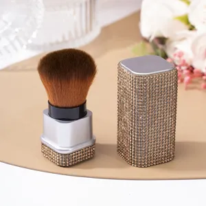Close-up of a sparkling rhinestone-studded nail dust cleaning and luxury makeup brush