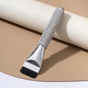 Flat-top foundation brush with sparkling rhinestone handle detail for smooth makeup application