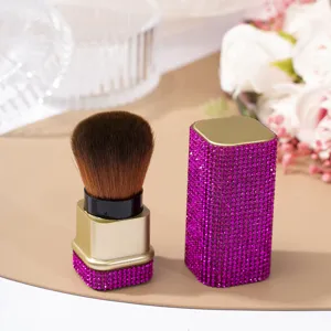 Close-up detail of luxury purple rhinestone-encrusted makeup brush for nail dust cleaning
