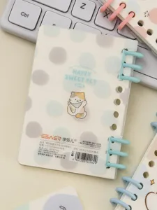 Detailed shot of A7 loose-leaf notebook featuring cute cat illustration and blue rings.