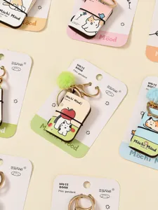 Cute mini PU leather notebook keychain with fluffy pom pom and adorable cat pendant for bags.