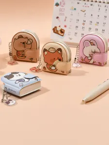 Cute mini notebook keychain set with adorable cartoon animal pendants for backpacks.