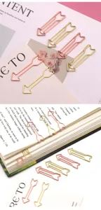 Creative arrow-shaped metal paper clips in gold and rose gold colors for office and file binding.