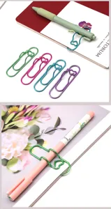 Detailed view of creative heart-shaped metal pen clips and colorful paperclip holders for notebooks.