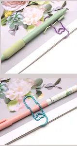 Creative heart metal pen clip for notebooks, cute paperclip holder, colorful stationery accessory.