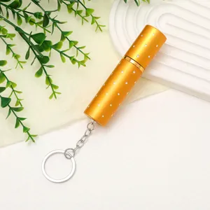 Detail view of a 10ml gold portable perfume atomizer with sparkling rhinestone dots.