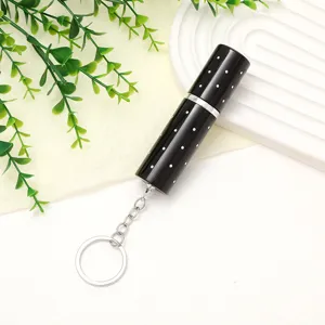 Close-up detail of a 10ml black polka dot mini perfume atomizer with a keychain.