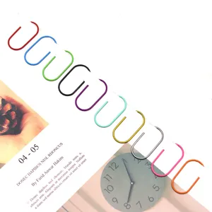 Detailed view of colorful plastic-coated metal paper clips arranged neatly on a magazine page.