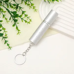Silver 10ml portable perfume atomizer bottle with elegant rhinestone detail and keychain