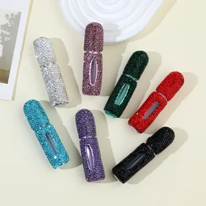 Macro view of refillable perfume bottles in various colors with sparkling rhinestone finish
