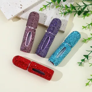Close-up of four luxury 5ml rhinestone-studded refillable perfume bottles in multiple colors