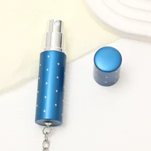 Detailed view of a 10ml blue portable perfume atomizer bottle with rhinestone embellishments