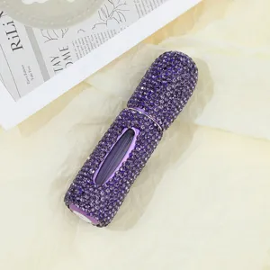 Detailed macro view of purple rhinestone-encrusted 5ml refillable perfume atomizer
