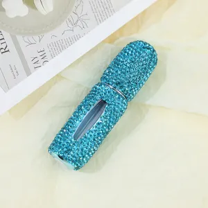Close-up detail of luxury blue rhinestone-encrusted handmade perfume atomizer bottle