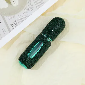 Detail view of luxury green rhinestone-encrusted 5ml refillable perfume atomizer bottle