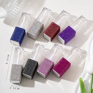 Close-up detail of travel lip gloss containers with colorful rhinestone encrusted caps