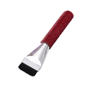 Detailed macro shot of flat foundation brush featuring a sparkling red rhinestone handle