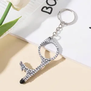 Detailed view of the sparkling rhinestone-encrusted no-touch door opener keychain.
