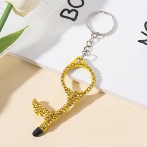 Detail view of yellow double-sided rhinestone encrusted door opener keychain with stylus tip