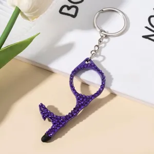 Close-up of purple rhinestone no-touch door opener tool keychain with stylus tip
