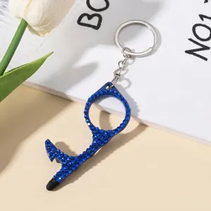 Detail of a blue rhinestone-encrusted portable door opener and stylus keychain