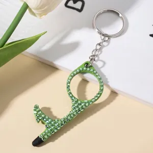 Detailed view of the green rhinestone-encrusted no-touch door opener tool keychain.