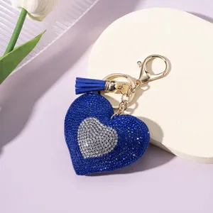 Close-up of sparkling blue and silver rhinestone heart keychain with blue tassel