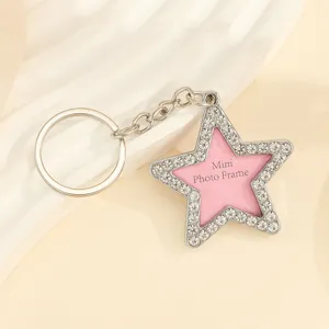 Close-up of star-shaped rhinestone keychain featuring mini photo frame insert