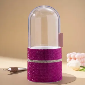 Detailed view of sparkling pink rhinestone makeup brush holder with clear protective dome lid