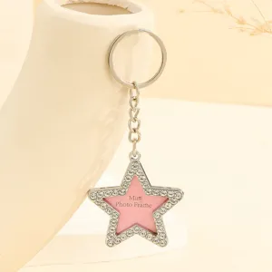 Close-up detail of a star-shaped rhinestone keychain with mini pink photo frame.