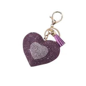 Sparkling purple rhinestone heart keychain with a matching tassel and gold hardware