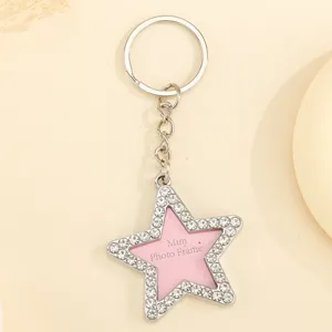 Star-shaped rhinestone keychain with a mini pink photo frame insert for couples.