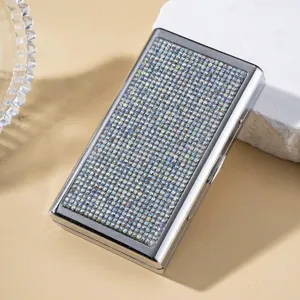 Detailed close-up showing iridescent rhinestones on a sleek silver metal cigarette case