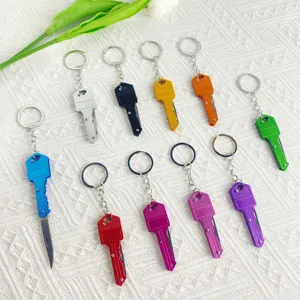 Detailed view of miniature key-shaped folding knives in a variety of vibrant colors
