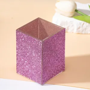 Detailed macro view of a sparkling purple rhinestone makeup brush holder for vanity