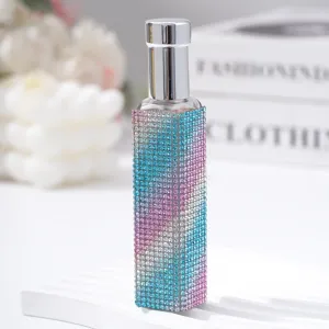 Detail of 10ml travel perfume spray bottle with blue and pink rhinestones