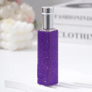 Close-up of a 10ml purple rhinestone-encrusted refillable perfume spray bottle.