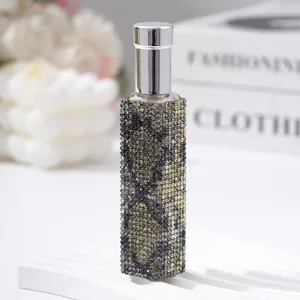 Close-up of a 10ml perfume spray bottle decorated with sparkling leopard print rhinestones.