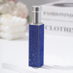 Detailed view of a 10ml portable perfume atomizer with blue rhinestone decoration