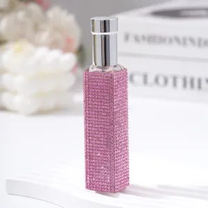 Close-up of a 10ml portable perfume spray bottle decorated with pink rhinestones
