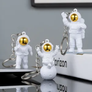 Cute astronaut keychain detail, PVC space man pendant and creative metal keyring for gifts.