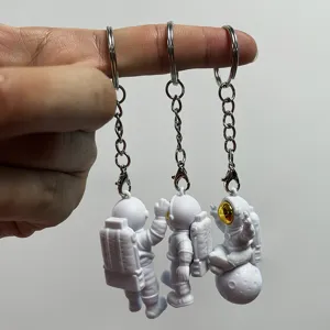 Cute astronaut keychain set, creative PVC soft rubber spaceman pendant for bags and car keys.