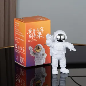 Details of the white astronaut figurine toy with colorful packaging box, cute room decor.