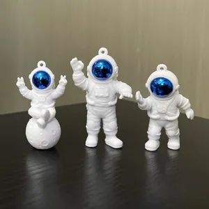 Cute astronaut keychain set, PVC soft rubber material with electroplated blue reflective visor.