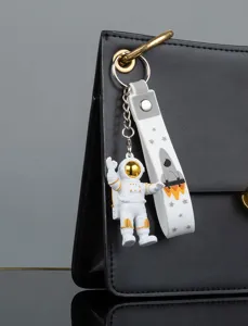 Astronaut keychain detail view, featuring cute space man pendant and rocket strap design.