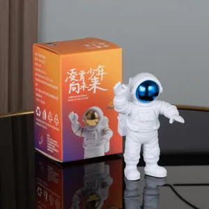 Astronaut figurine ornament detailed shot, white PVC spaceman toy with colorful packaging.