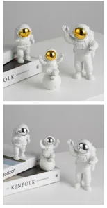 Detailansicht kreativer Astronauten Figuren Tischdekoration mit goldenen und silbernen Visieren.