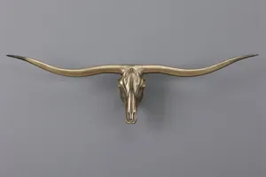 Detailed shot of a vintage bronze longhorn bull skull wall hanging for industrial decor