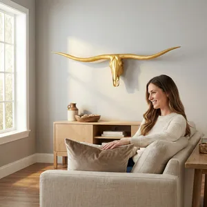Gold longhorn bull skull wall decor detail in a rustic living room interior setting.
