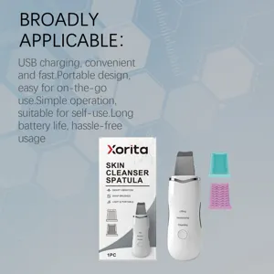 Ultrasonic skin scrubber detail view showing spatula device, box and silicone brush heads.